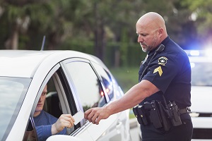 police handing man a ticket